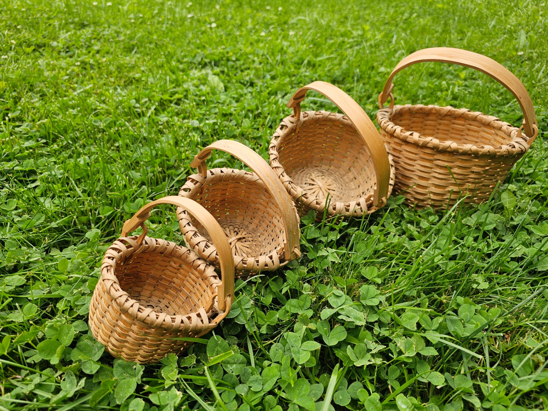 A stack of four nesting Taghkanic ash splint baskets, smallest tucked inside the next.
